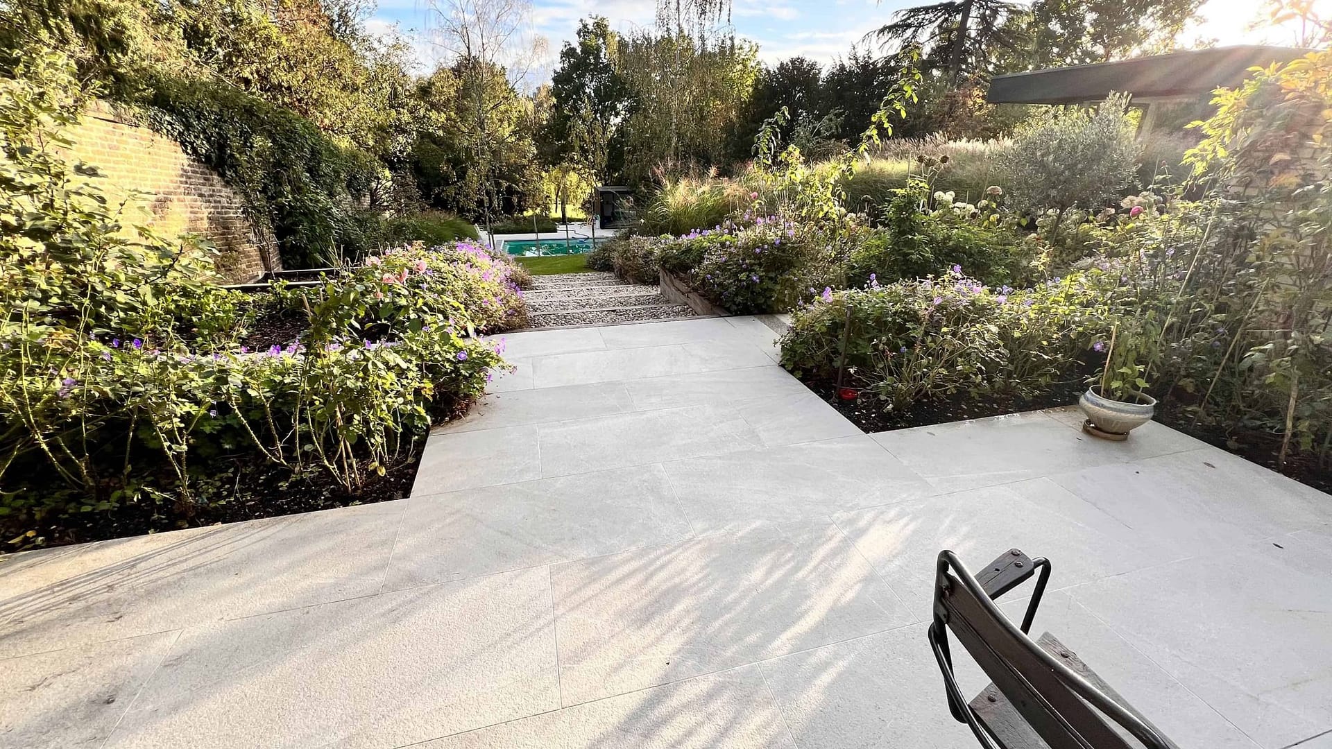 mature natural garden featuring a new porcelain pathway